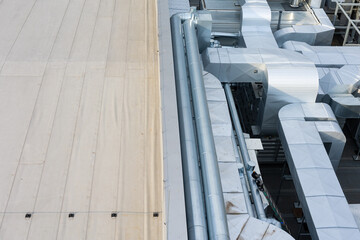 Ducts of the ventilation and air conditioning system on the roof of the building. The photo was...