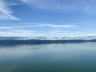 Obraz premium Trasimeno lake view from Castiglione del Lago in Umbria, Italy. View of Lake Trasimeno from Castiglione del Lago in early autumn. Umbria, Italy. Trasimeno lake panoramic view, Umbria, Italy.