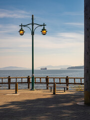 Glowing street lamp at the harbour in Vancouver Island. View from the pier.