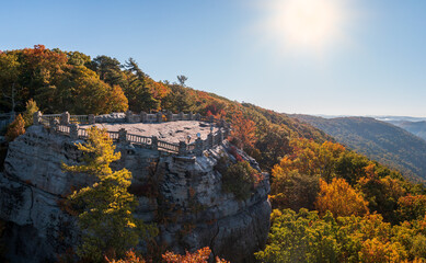 View up the Cheat River gorge in the autumn with Coopers Rock overlook in the colorful trees near...