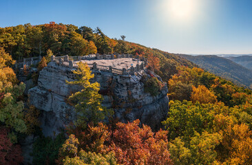 View up the Cheat River gorge in the autumn with Coopers Rock overlook in the colorful trees near...