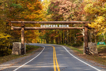 New wood tree trunk entrance sign over the road to Coopers Rock State Forest