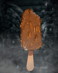 chocolate cream popsicle on a black background