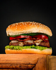 homemade beef burguer with guacamol, onions, tomato and lettuce