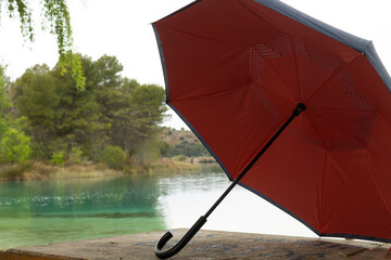 orange umbrella on a table with lagoon background