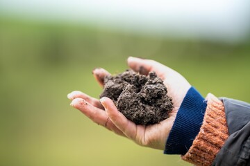 female farmer testing soil on a farm