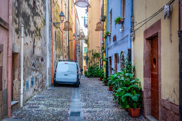 White car parked in a narrow alley in old town Bosa