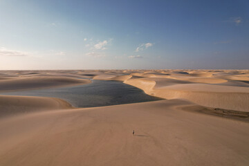 Fototapeta na wymiar Sunset over the White Sand Dunes among lakes with blue water, aerial view