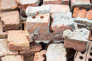 Red bricks with round holes at a construction site.