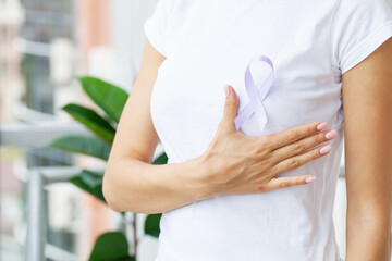 Woman holding purple ribbon, domestic violence awareness