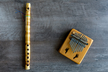 A Flute and a Kalimba on a wood background © Charles Riesco