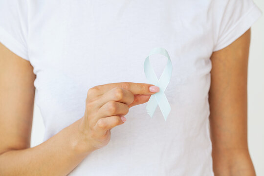 Brain Cancer Awareness month, woman hand holding white color Ribbon