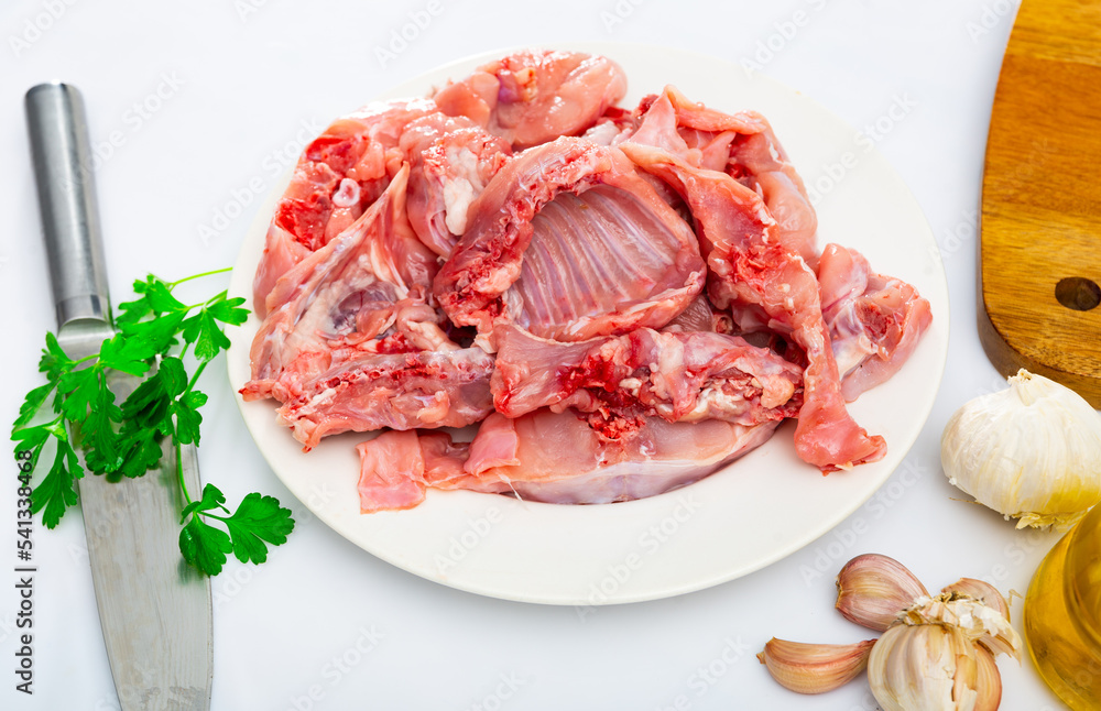 Wall mural rabbit sliced with herbs in white plate prepared for cooking in restaurant