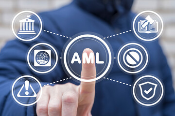 Businessman using virtual touchscreen presses abbreviation: AML. Concept of AML Anti Money...