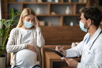 Sick Pregnant Woman Wearing Medical Mask Having Appointment With Therapist Doctor