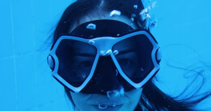 young woman diving in swimming pool