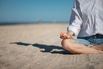 Girl practice meditation on the beach. With space for text or design