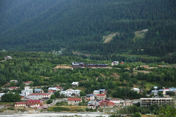 Fototapeta na wymiar Picturesque view of small town near mountain forest