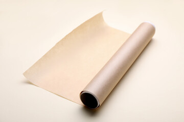 Roll of baking paper on beige background