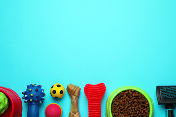 Pet toys, food and brush on light blue background, flat lay. Space for text