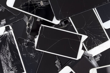 Prague, CZ - 16 January 2022:  Heap, A lot of used broken  iPhone Screens on white bg. Crashed...