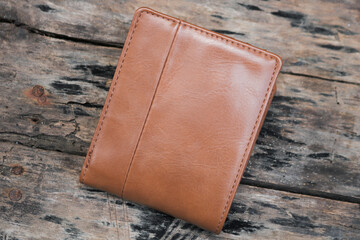 Brown leather wallet on a wooden table