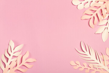 pink background with sheets of paper neutral colors