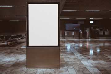 View of a vertical empty indoor advertising billboard mockup; a blank poster template in an airport terminal waiting hall; banner placeholder mock-up on a railway station depot with a copy space area