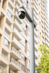 CCTV cameras and residential building on back vertical composition