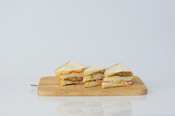 Homemade sandwich on wood plate,on white background.