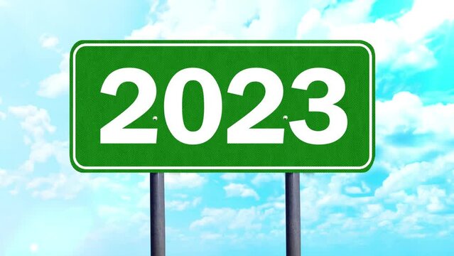 Green street sign with 2023 number under clear sky