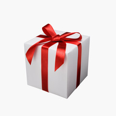 Gift box decorated with red ribbon.