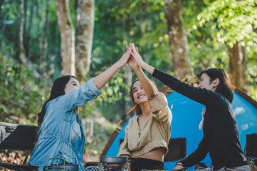 Group of women giving five to each other on camping