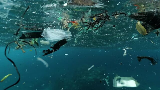 Garbage Floating In Wavy Undersea - Oahu, Hawaii