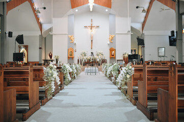 Wedding decoration indoors. Cathedral, church decoration for ceremonial wedding. Grooms and Bride