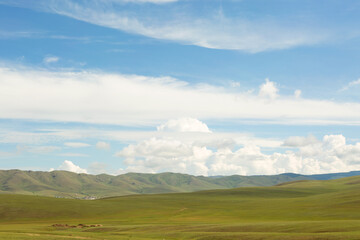 Summer Mongolian Steppe, Mountains and Blue Sky with Clouds