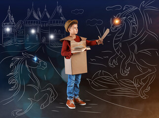 Cute little boy dressed as knight holding book in drawn magic kingdom on dark background