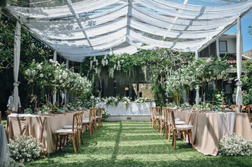 Ornamental decorations with multi flora. Outdoors light. Wedding ceremony or wedding decoration with clear tent in the sunny afternoon natural lights. © David