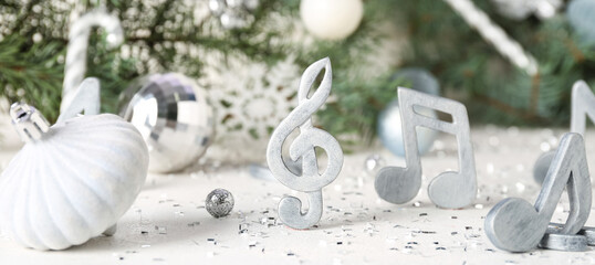 Fototapeta na wymiar Music notes with Christmas decorations on light table