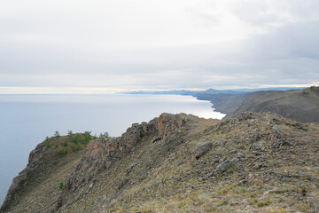 Beautiful summer landscape of Baikal Lake on sunny day. View of the rocky cape