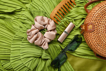 Stylish female accessories on green dress