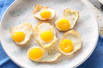 Plate with tasty fried quail eggs, closeup, closeup