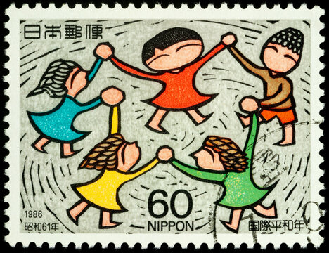 Circle of laughing children on postage stamp