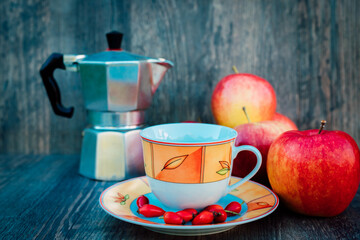 A cup of tea, rose hips, apples and a kettle. Vitamins, disease prevention