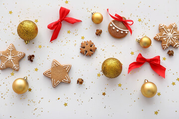 Composition with Christmas balls and cookies on white background