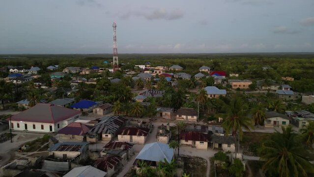 Radio tower and homes near Uroa Beach Zanzibar Tanzania Africa, Aerial flyover shot