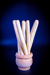 Italian breadsticks grissini on dark background
