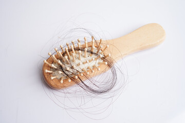 Hair loss fall with comb brush isolated on white background.