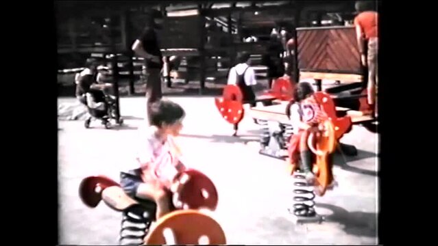 Amusement Park, Children playing on Playground Spring Rockers - 1970s vintage video 8mm