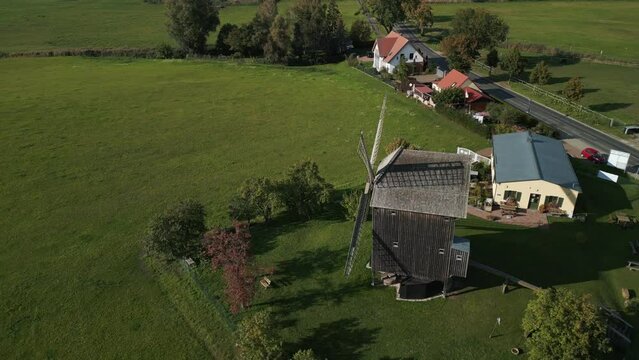 Wonderful aerial view flight speed ramp Hyperlapse motionlapse timelapse
of a old Wooden Trestle windmill in brandenburg Germany at summer golden hour 2022. 4k marnitz Cinematic